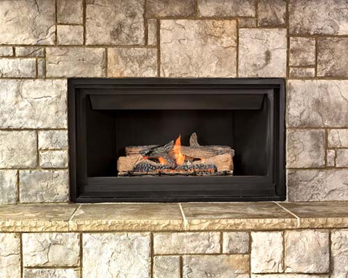 Gas fireplace with fire and nice stone work surround
